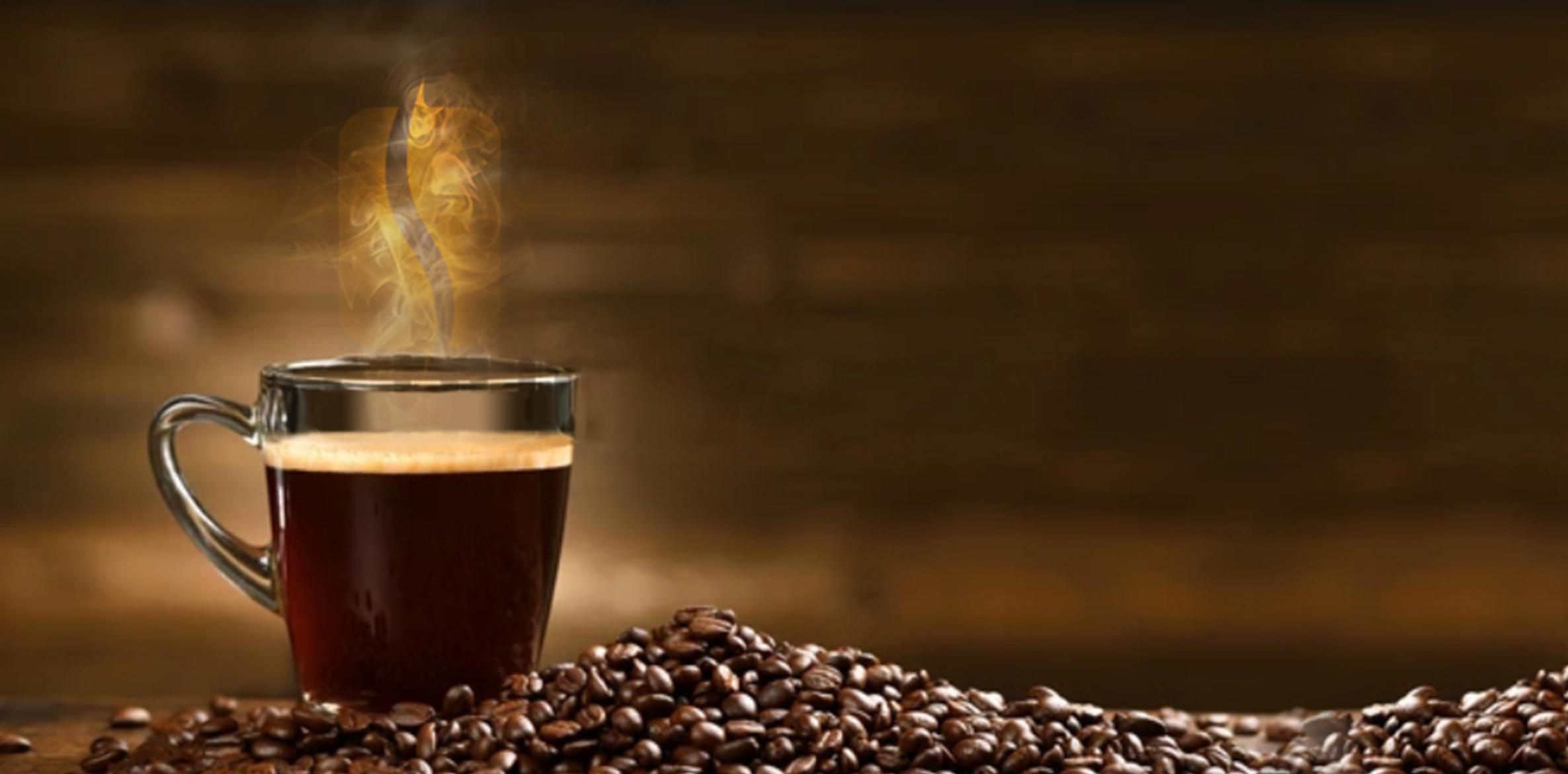 Image-Top Steaming cup of coffee on a rustic wood table surrounded by roasted coffee beans, representing Ricco Coffee’s warm, artisan approach to craft roasting